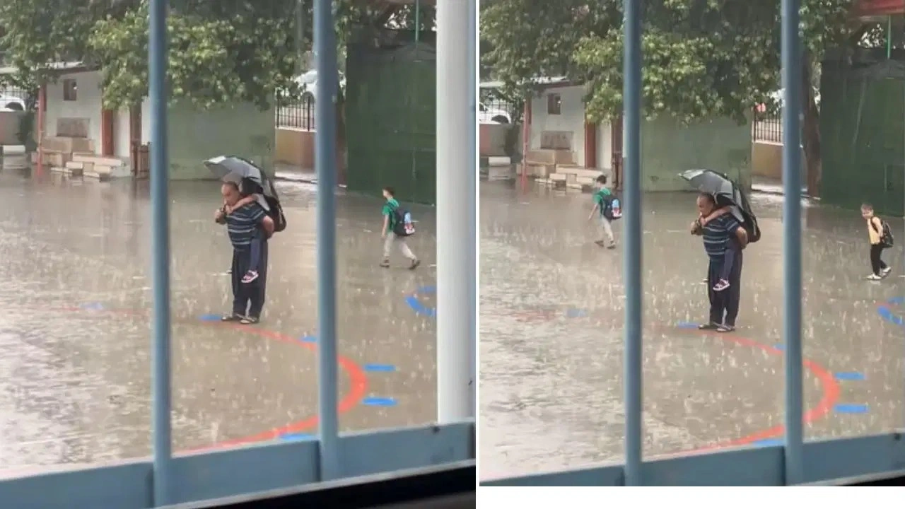 Sağanak altında torunu ile İstiklal Marşı'nı dinlediler